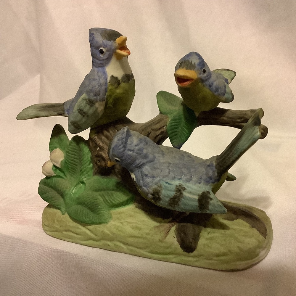 Decorative vintage painted ceramic trio of blue birds on a branch